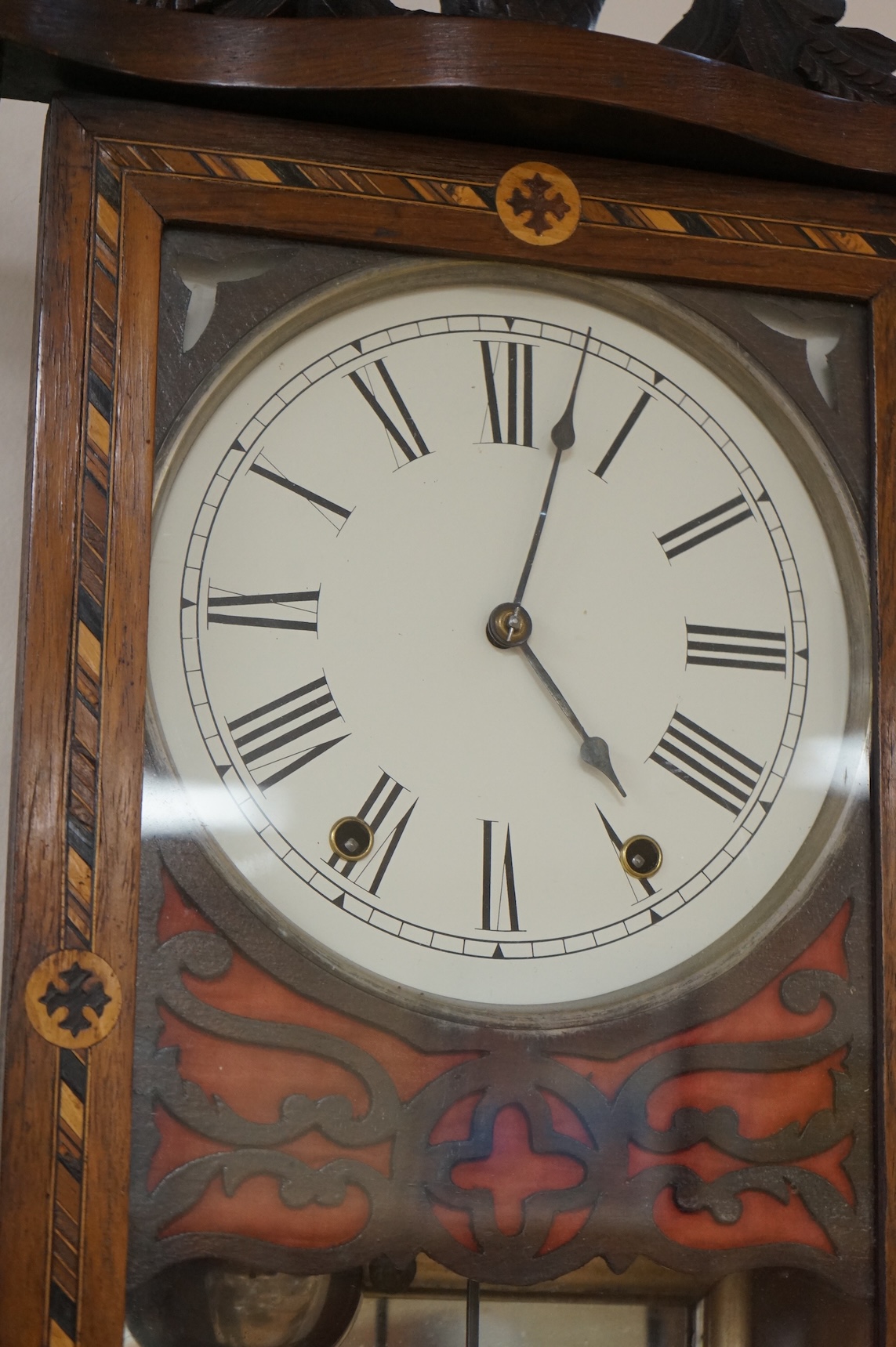 A German inlaid walnut wall clock, 84cm high, with pendulum.